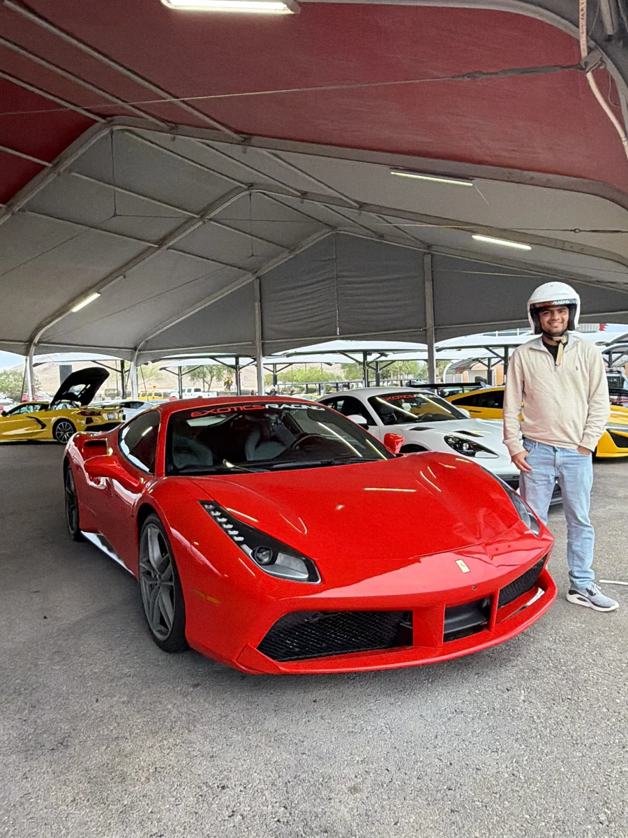 Nayan Bhatia beside a Ferrari before a driving experience